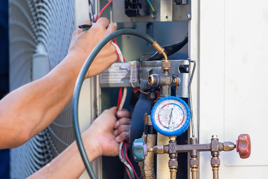 Technician checking AC refrigerant levels
