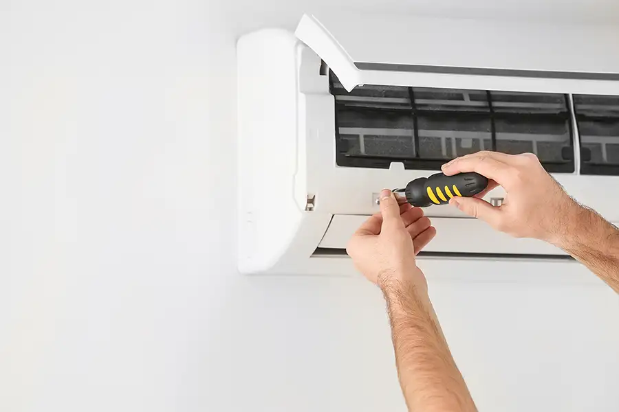 Technician repairing wall mounted AC